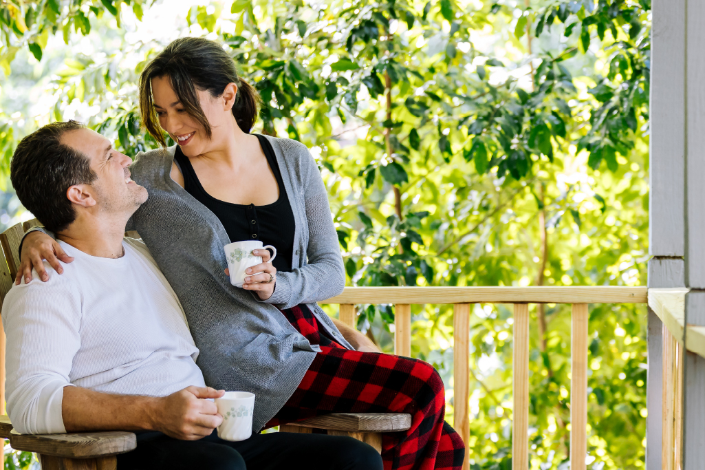 Couple having coffee on vacation rental porch