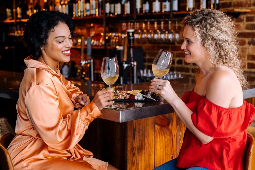 Friends enjoy wine and charcuterie