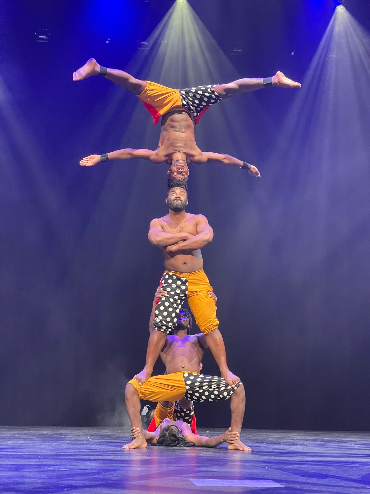Picture of the Zuzu African Acrobats doing a seemingly dangerous stunt.