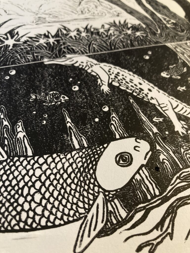 Close-up of the original winning artwork, showcasing a detailed black and white illustration of fish swimming underwater. The foreground features a large fish with intricate scale patterns, while smaller fish and aquatic plants fill the midground and background. The scene is rendered with fine linework and textures, suggesting a woodcut or linocut print style.