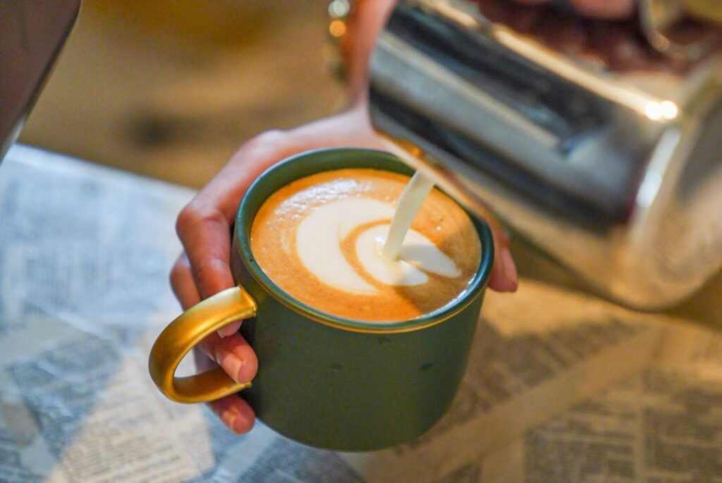 Creating coffee art at Two Story Books and Coffeehouse.
