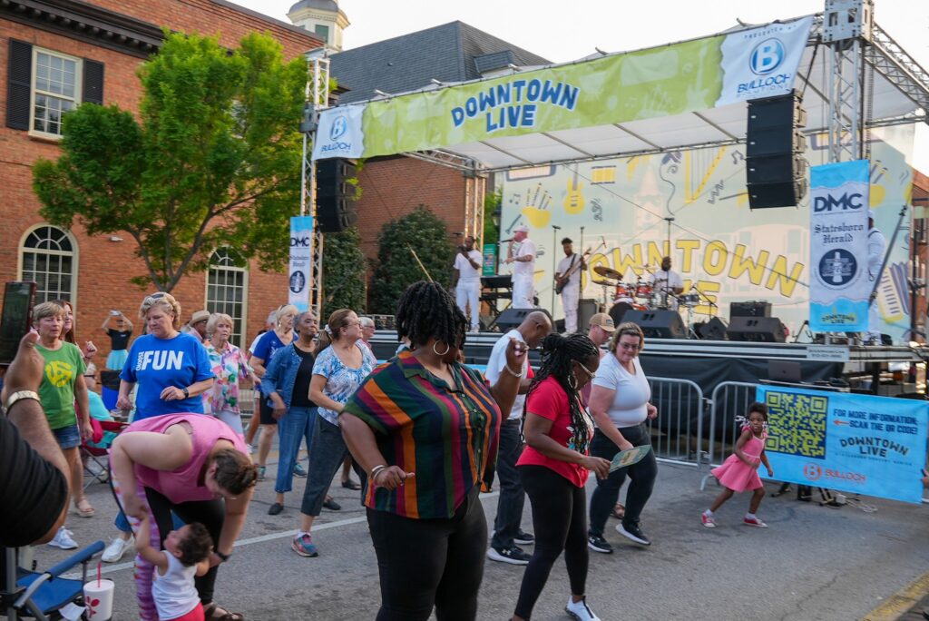 Photo of the community Dancing along to a song at the Downtown live Event.