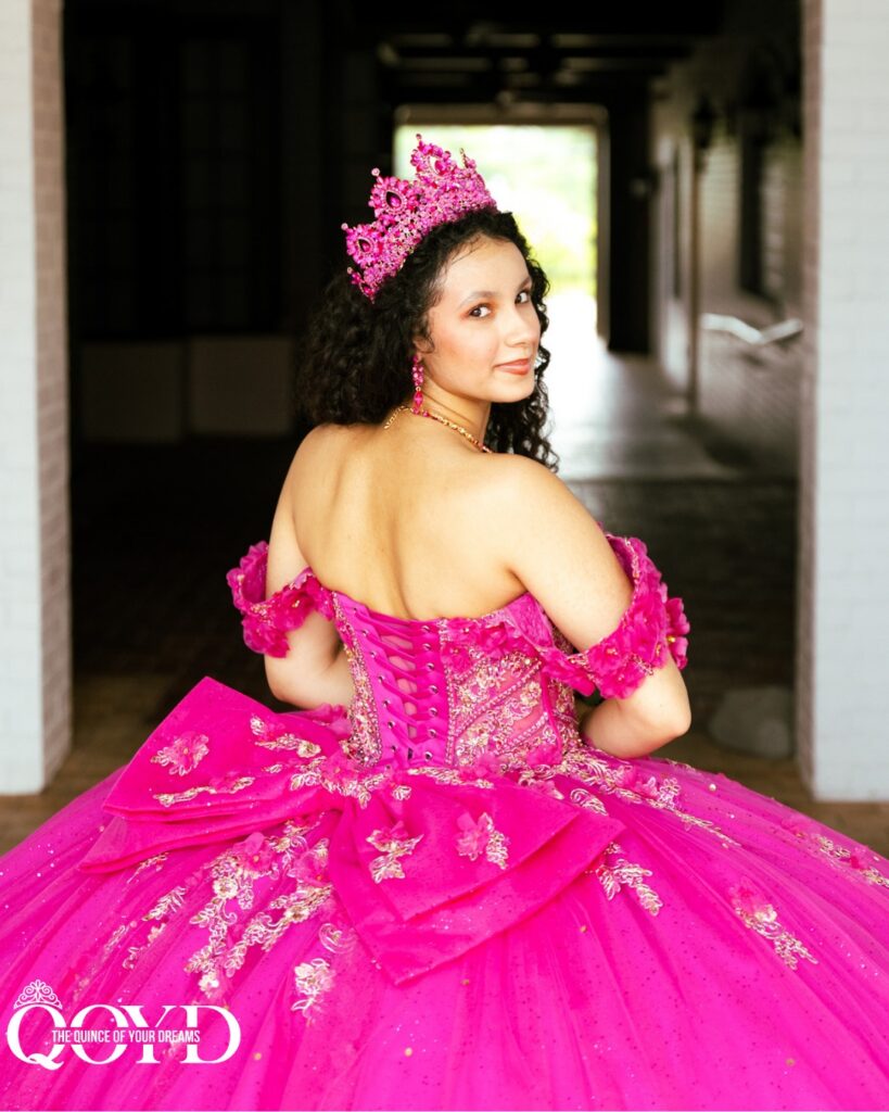 Quinceañera wearing a bright pink ball gown and tiara from The Quince Of Your Dreams dress shop in Statesboro, Georgia.