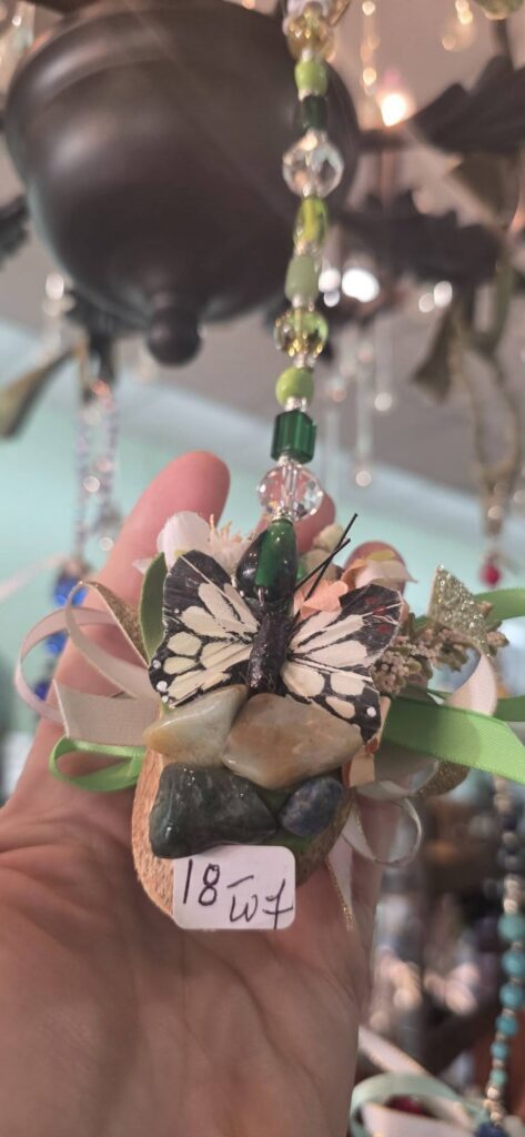 Handcrafted butterfly ornament with beads, ribbons, and polished stones, sold at The Raven’s Roost Boutique.