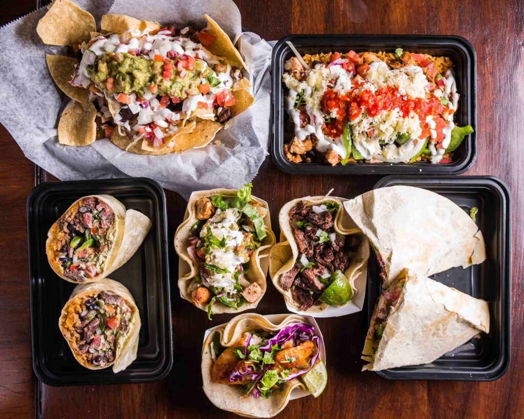 Assorted tacos, burritos, nachos, and burrito bowls from Diablo’s restaurant in Statesboro, topped with fresh salsa, cheese, guacamole, and cilantro.